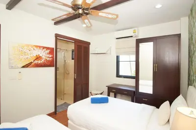 a bedroom with a bed and a ceiling fan at Baan Ping Tara Private Pool Villa in Ao Nang Beach