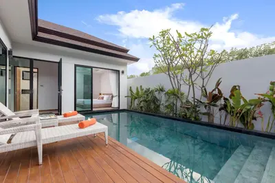 a villa with a swimming pool and a house at La Ville Phuket Pool Villa in Nai Yang Beach