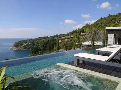 a pool with a bench and a view of the ocean at Villa Saan - SHA Extra Plus in Kamala Beach