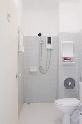 a bathroom with a shower and a toilet at Hao Hostel Phuket in Phuket Town