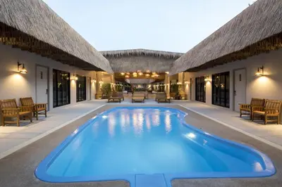 a swimming pool in the middle of a house at Ozone Villa Phuket in Ban Pa Khlok