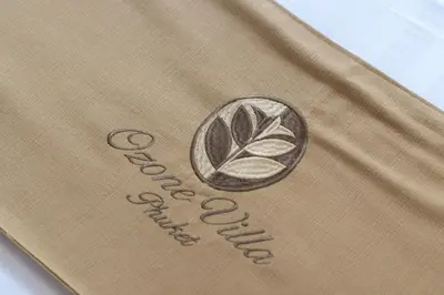 a brown bag with a logo on it at Ozone Villa Phuket in Ban Pa Khlok