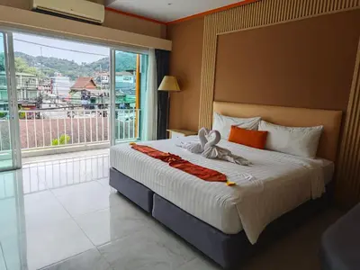 a bedroom with a bed with a bow on it at Chabana Kamala Hotel in Kamala Beach