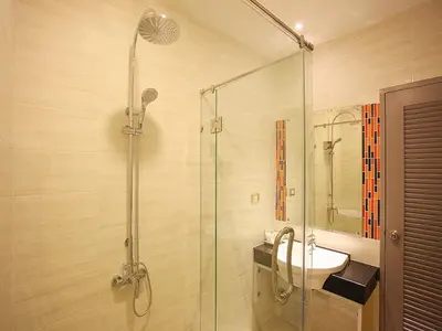 a bathroom with a glass shower and a sink at Chabana Kamala Hotel in Kamala Beach