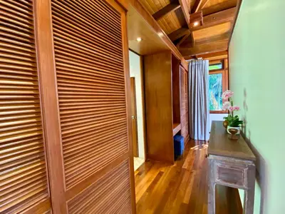 a wooden door in a room with a table at Luxury Seaview Villa Surin Beach Phuket in Surin Beach