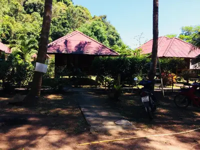 a building with a pathway in front of some trees at Namtok Bungalows in Ko Yao Noi