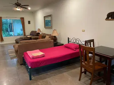 a living room with a couch and a table at Vacation Garden Villa in Thalang