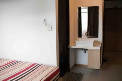 a bathroom with a sink and a mirror at The C Park in Patong Beach
