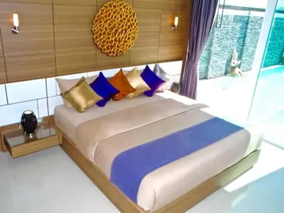 a bedroom with a large bed with colorful pillows at Skylight 2 bedrooms Villa in Kamala in Kamala Beach