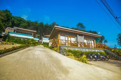 a house with motorcycles parked in front of it at Koh Yao Yai Hillside Resort in Ko Yao Yai