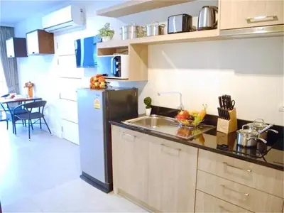 a kitchen with a sink and a refrigerator at Bliss Patong 2 bedrooms Apartment in Patong Beach