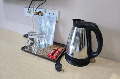 a black coffee pot sitting on top of a table at JJ Residence Phuket Town in Phuket Town