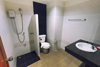 a bathroom with a shower and a toilet and a sink at JJ Residence Phuket Town in Phuket Town