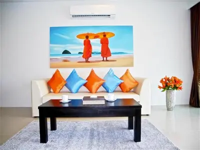 a living room with a couch and a table at Patong Bay Hill 1 bedroom Apartment in Patong Beach