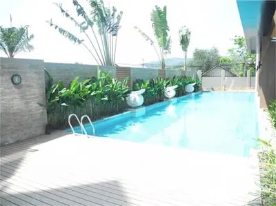 a swimming pool in a backyard with plants at Chic Karon Nice Apartment close to Karon Beach in Karon Beach
