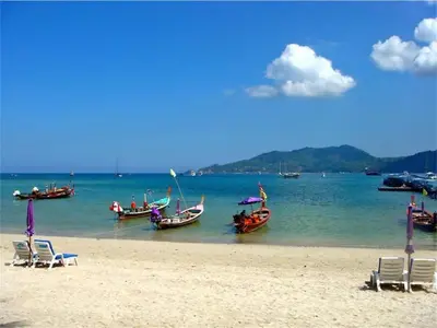 a group of boats in the water on a beach at Emerald Patong New Studio with Balcony in Patong Beach
