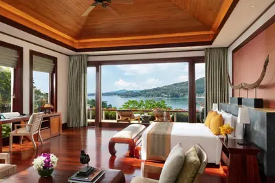 a bedroom with a bed and a view of the water at Andara Resort Villas in Kamala Beach