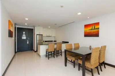 a kitchen and dining room with a table and chairs at The Palms, Kamala Beach - SHA Extra Plus in Kamala Beach