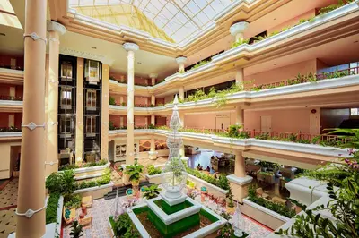 an indoor shopping mall with a fountain in the middle at Beyond Kata in Kata Beach