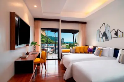 a hotel room with two beds and a television at Avani Ao Nang Cliff Krabi Resort in Ao Nang Beach
