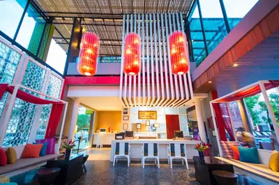 a restaurant with a table and chairs and lights at Red Ginger Chic Resort in Ao Nang Beach