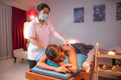 a woman in a bed with a woman in a mask at Red Ginger Chic Resort in Ao Nang Beach