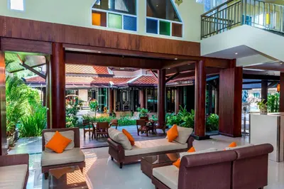 an outdoor living room with couches and tables at Nipa Resort, Patong Beach in Patong Beach