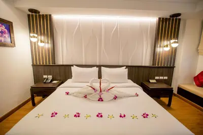 a bedroom with a bed with a flower decoration on it at Nipa Resort, Patong Beach in Patong Beach