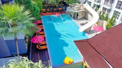 an overhead view of a swimming pool with umbrellas at Phuvaree Resort in Patong Beach