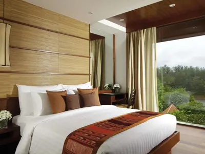 a bedroom with a large bed and a large window at Mövenpick Resort Bangtao Beach Phuket in Bang Tao Beach