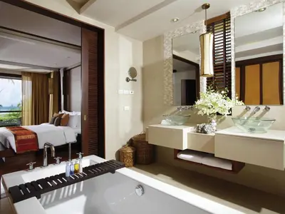a bathroom with two sinks and a large mirror at Mövenpick Resort Bangtao Beach Phuket in Bang Tao Beach