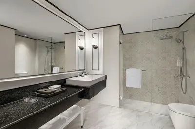 a bathroom with a sink and a shower at Courtyard by Marriott Phuket Town in Phuket Town