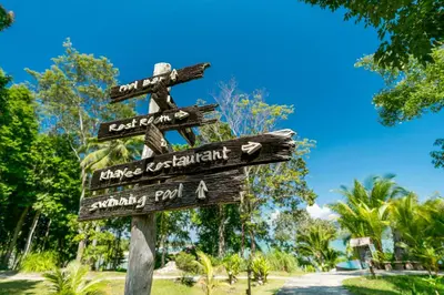 a wooden sign with arrows on a pole at Koh Yao Yai Village in Ko Yao Yai