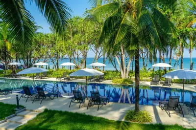a pool at the resort with chairs and umbrellas at Sunwing Kamala Beach in Kamala Beach