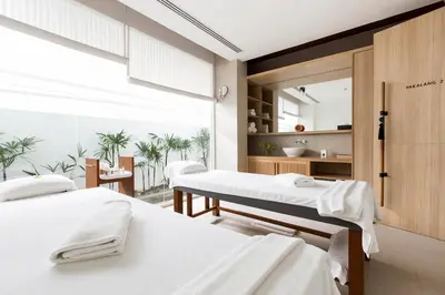 two beds in a hospital room with a window at Nap Patong in Patong Beach