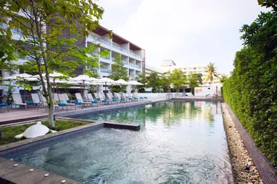 a swimming pool in front of a building at Nap Patong in Patong Beach