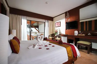 a hotel room with a bed with a swan on it at Baan Karonburi Resort in Karon Beach