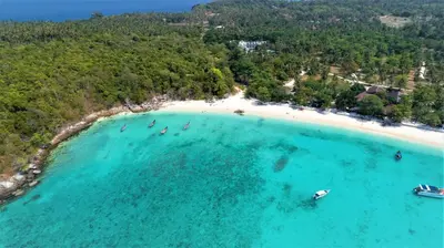 an aerial view of a beach with boats in the water at Racha Island Resort (Rayaburi) in Ko Racha Yai