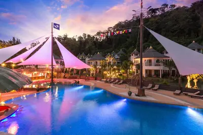 a large pool with white umbrellas in a resort at Krabi Resort in Ao Nang Beach