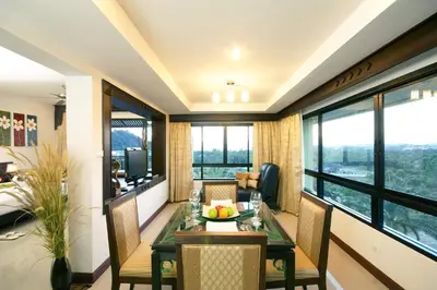 a room with a table with a bowl of fruit on it at Palm Paradise, Aonang Resort in Ao Nang Beach