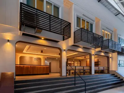 a building with a staircase in the middle of it at Panmanee Hotel-Newly Renovated in Phi Phi Don
