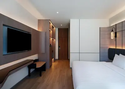 a hotel room with a bed and a tv at Panmanee Hotel-Newly Renovated in Phi Phi Don