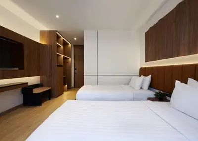 a hotel room with two beds and a tv at Panmanee Hotel-Newly Renovated in Phi Phi Don