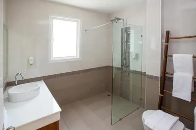 a bathroom with a glass shower and a sink at Baan Anna in Ao Nang Beach