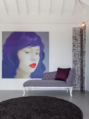 a living room with a painting of a woman with purple hair at Sammasan Seaview Villa by Elite Havens in Surin Beach