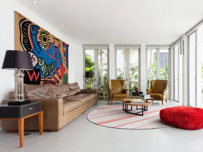 a living room with a brown couch and chairs at Sammasan Seaview Villa by Elite Havens in Surin Beach