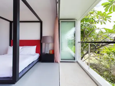 a bedroom with a bed and a large window at Sammasan Seaview Villa by Elite Havens in Surin Beach