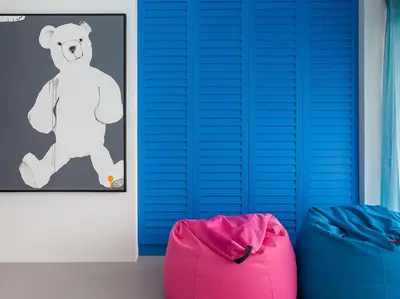 a room with blue shutters and a teddy bear at Sammasan Seaview Villa by Elite Havens in Surin Beach