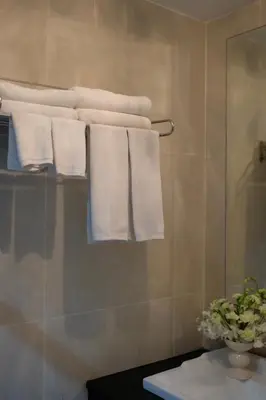 a group of towels hanging on a rack in a bathroom at Sun Sea Sand Patong in Patong Beach