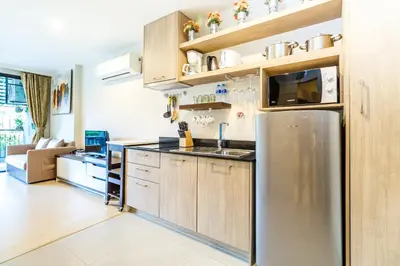 a kitchen with a stainless steel refrigerator at Apartments at The Bliss Condo by Lofty in Patong Beach